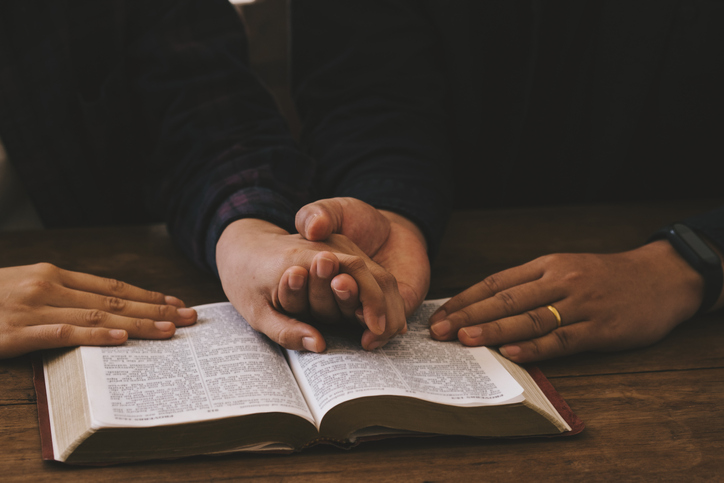 Two lovers Pray for god blessing to wishing have a better life. woman hands praying to god with the bible. begging for forgiveness and believe in goodness. Christian life crisis prayer to god.