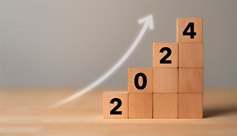 Business growth concept in 2024. Business goals and achievement. Sustainable development. Wooden cubes inscripted 2024 and growth icon on smart background. Positive indicators banner.