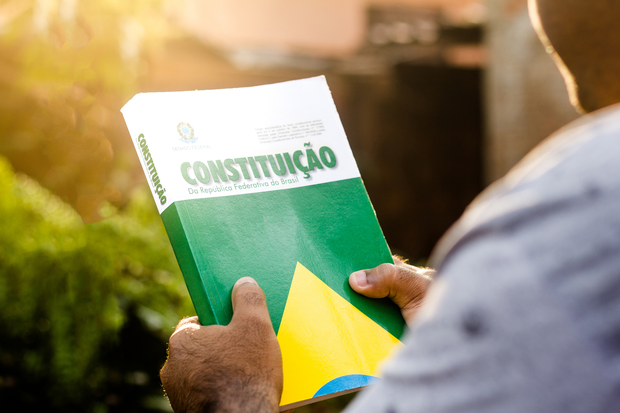 Man holds the Constitution of the Federative Republic of Brazil