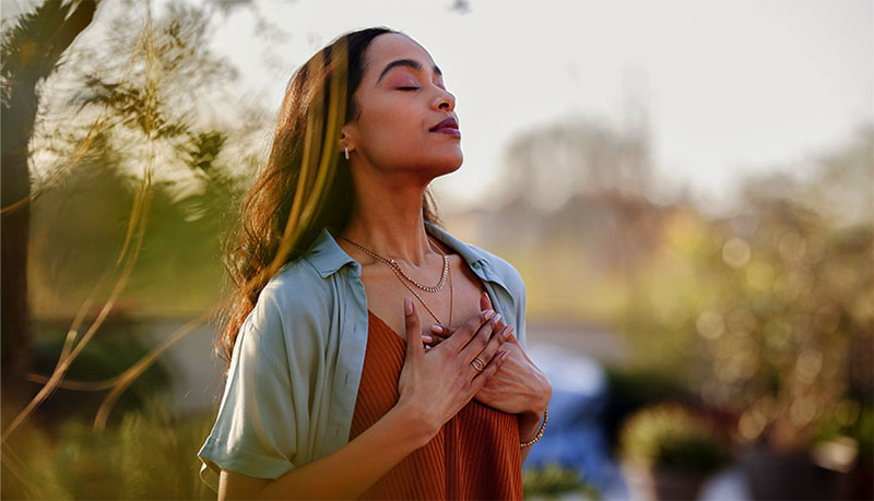Mixed race woman relax and breathing fresh air outdoor at sunset