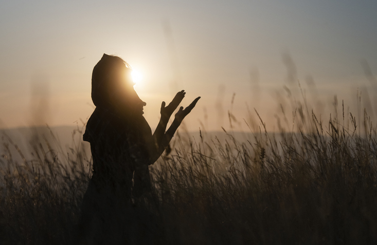 Silhouette of Muslim woman praying