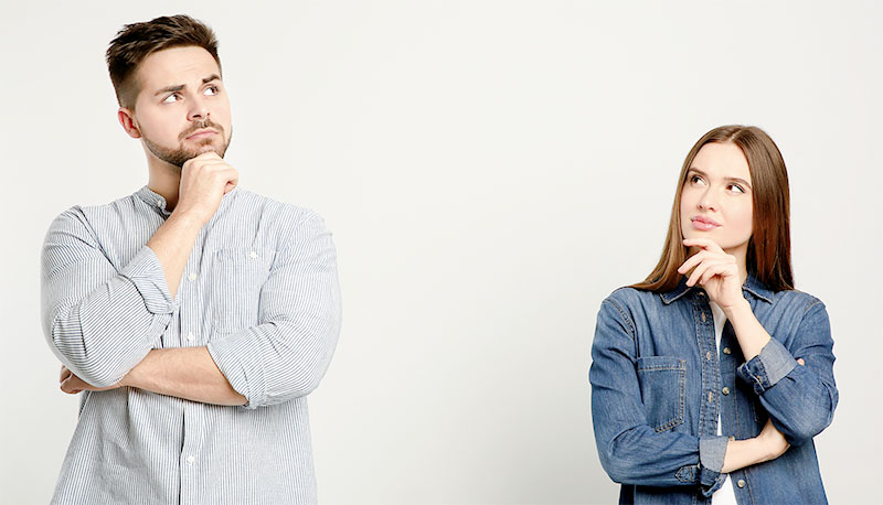 Pensive couple on light background. Thinking about answer for question