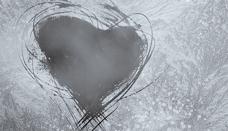 scratched heart on frosty window