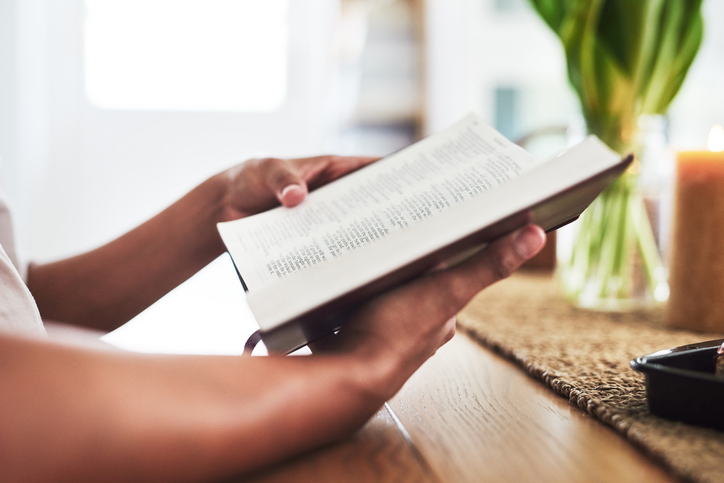 Shot of an unrecognizable female reading the bible