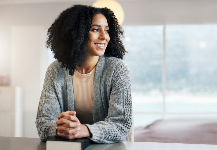 Thinking happy woman, bible book or praying for hope, help or support in Christianity religion or holy faith. Smile, prayer or girl studying, dream or worshipping God in spiritual literature at home