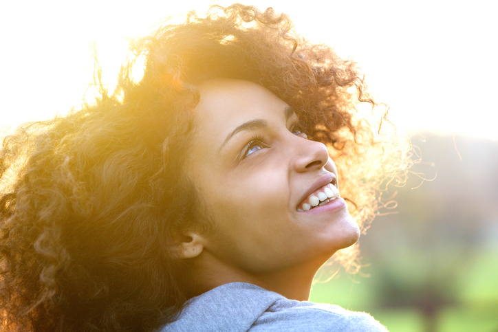 Young african american woman smiling and looking up