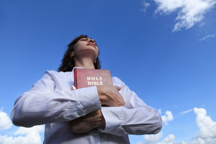 portrait of young woman holding Holy Bible