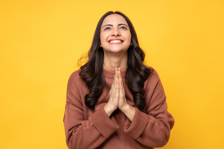 Photo of young women in winter wear standing on yellow background stock photo