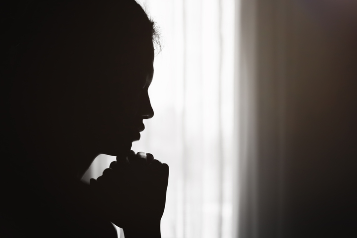 Silhouette of  Christian life crisis prayer to god.  woman hands praying to god. begging for forgiveness and believe in goodness.