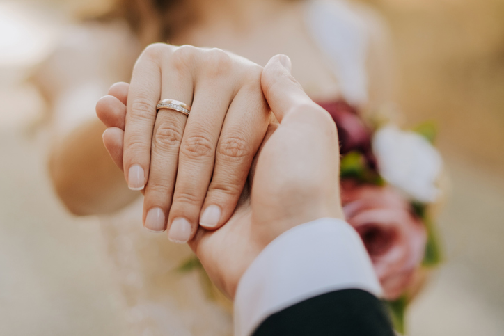 man holding his girlfriend&#8217;s hand and woman showing her ring