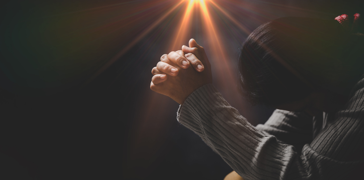 Prayer person hand in black background. Christian catholic woman are praying to god in dark at church. Girl believe and faith in jesus christ. Christ religion and christianity worship or pray concept.