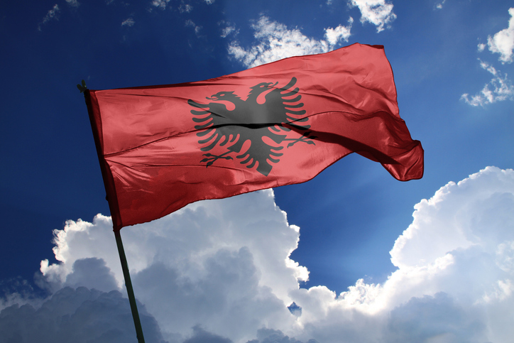 national flag of Albania waving in the wind on a clear day.