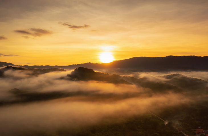 Beautiful morning scene with sunrise and fog above the mountains