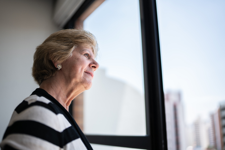 Senior woman looking away contemplating at home