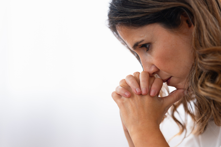 Close-up of a sad woman thinking looking down