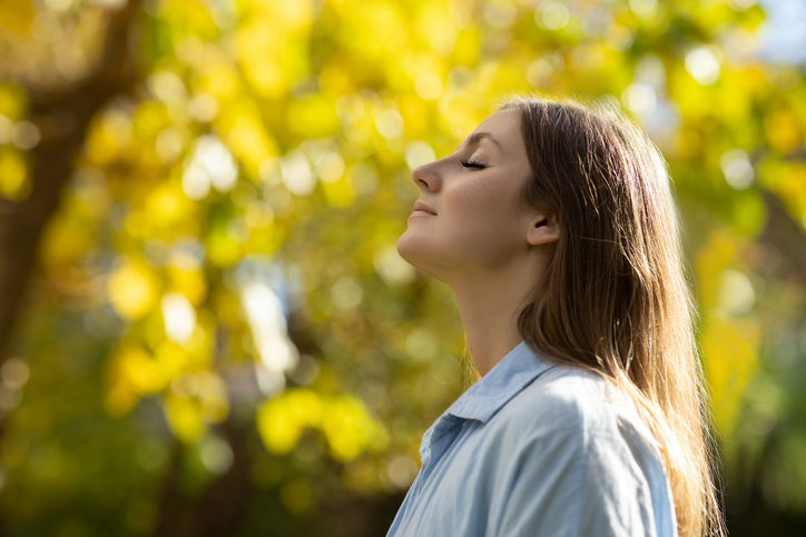 Woman with closed eyes in nature