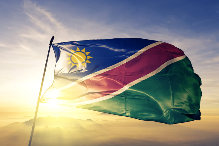 Namibia Namibian flag textile cloth fabric waving on the top sunrise mist fog