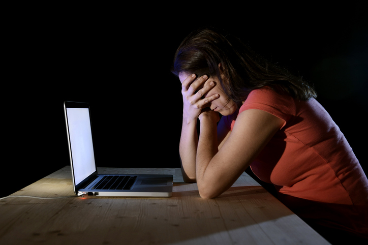 depressed worker or student woman working with computer alone l