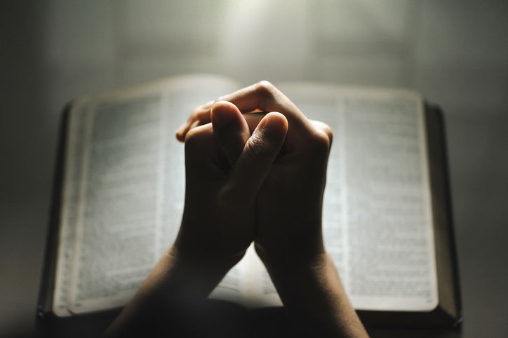 Women pray from god blessing to have a better life. Women hands praying to god with the bible. believe in goodness. Holding hands in prayer on a wooden table. Christian life crisis prayer to god.