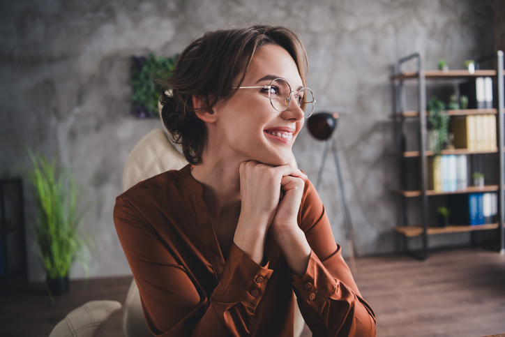 Photo of lovely young lady look dreamy empty space dressed brown satin shirt startup office room interior