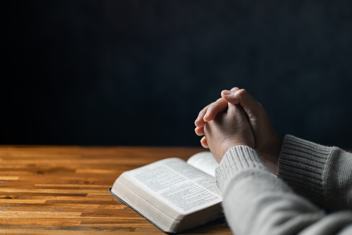 Christian life crisis prayer to god. Woman Pray for god blessing to wishing have a better life. woman hands praying to god with the bible. begging for forgiveness and believe in goodness.