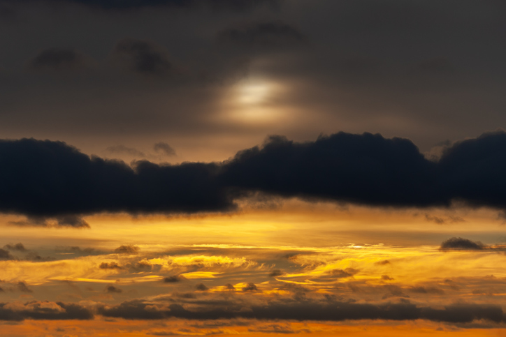 Dramatic view on a dark orange cloudy sky