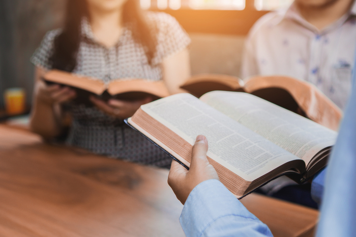 A Group of Christian friends are reading and study bible together