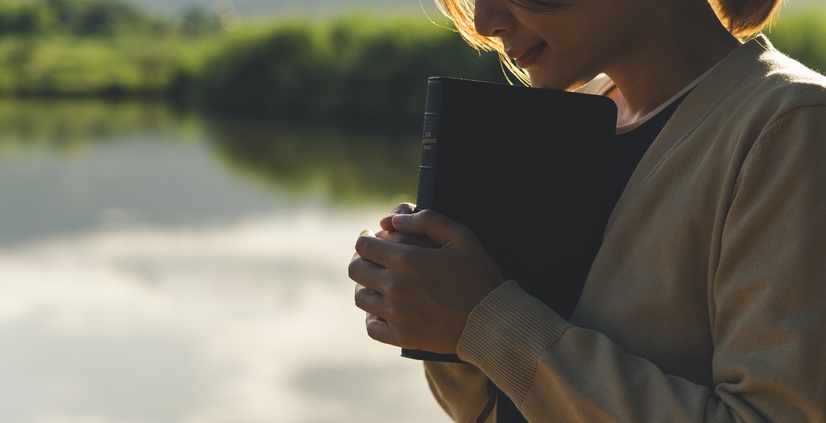 Young woman praying to god with the bible, Christianity,