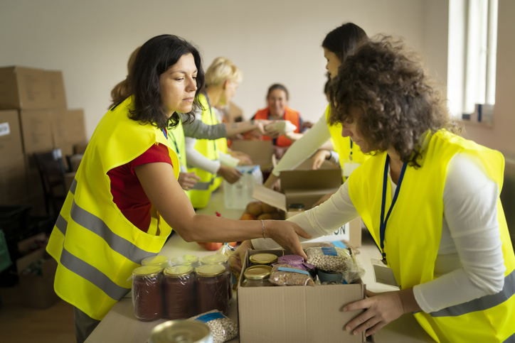 Female volunteers packing food for donation