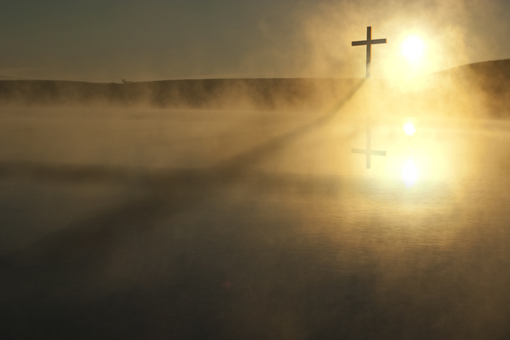 Single Cross Long Shadow Sunrise on Foggy Lake Easter Morning