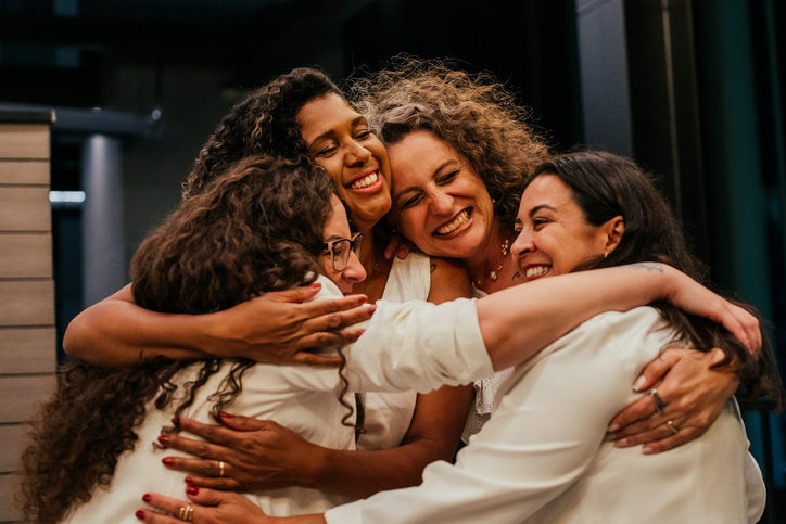 Female friends hugging each other on New Year&#8217;s Eve