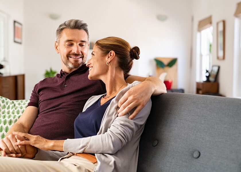 Mature couple in love sitting on couch