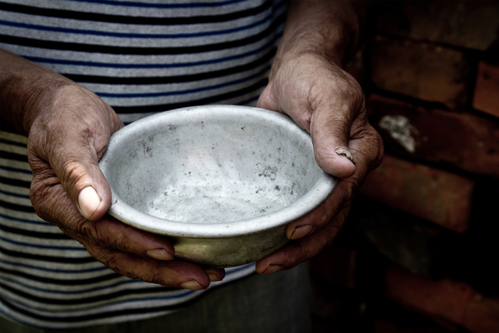The poor old man&#8217;s hands hold an empty bowl. The concept of hunger or poverty. Selective focus. Poverty in retirement. Homeless. Alms