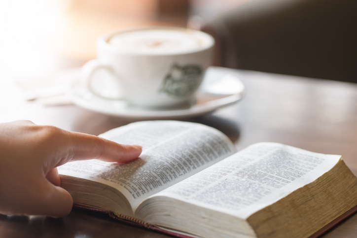 Woman&#8217;s hands on a Bible, studying and reading.