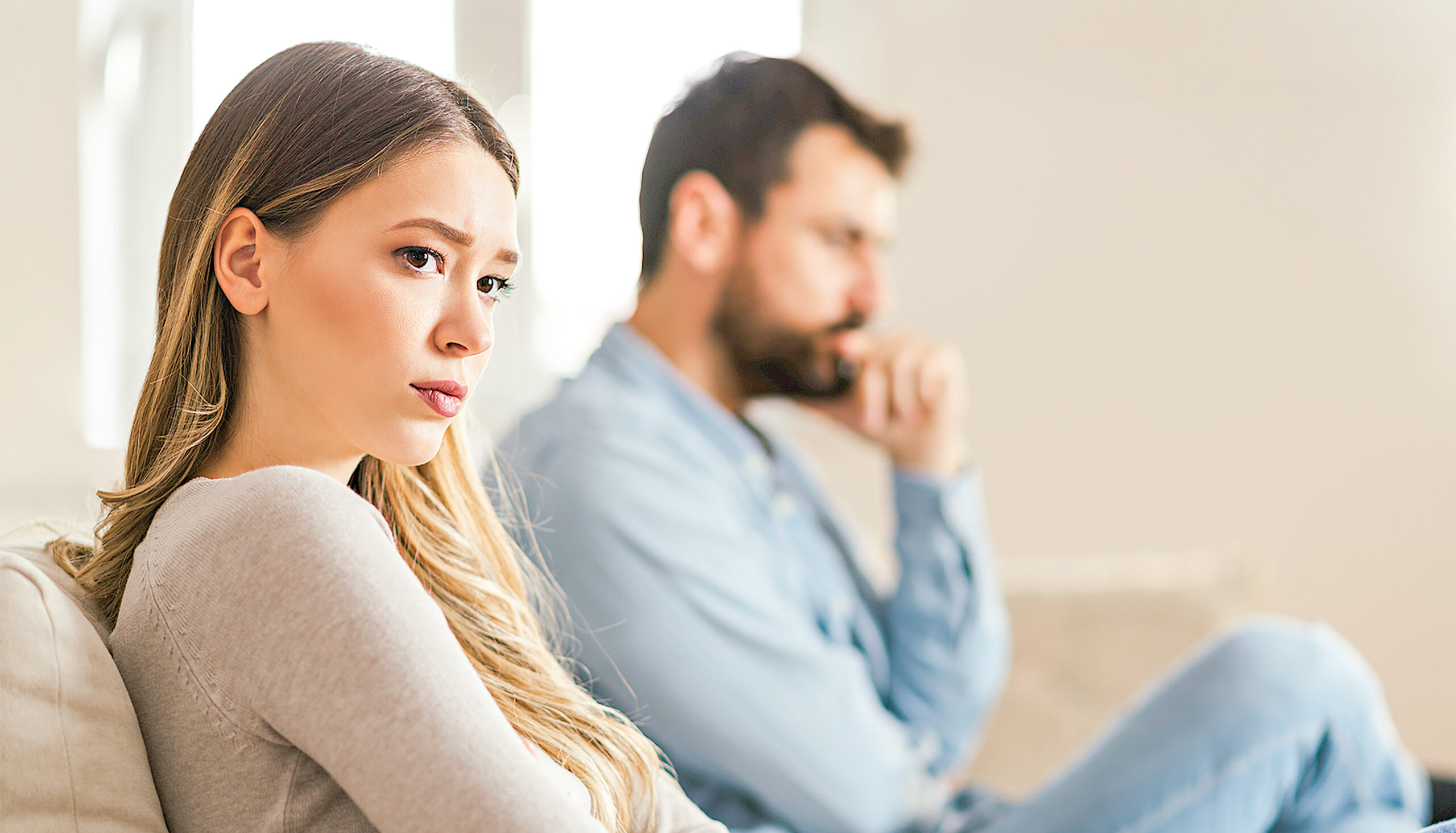 Young sad woman having relationship difficulties with her boyfriend