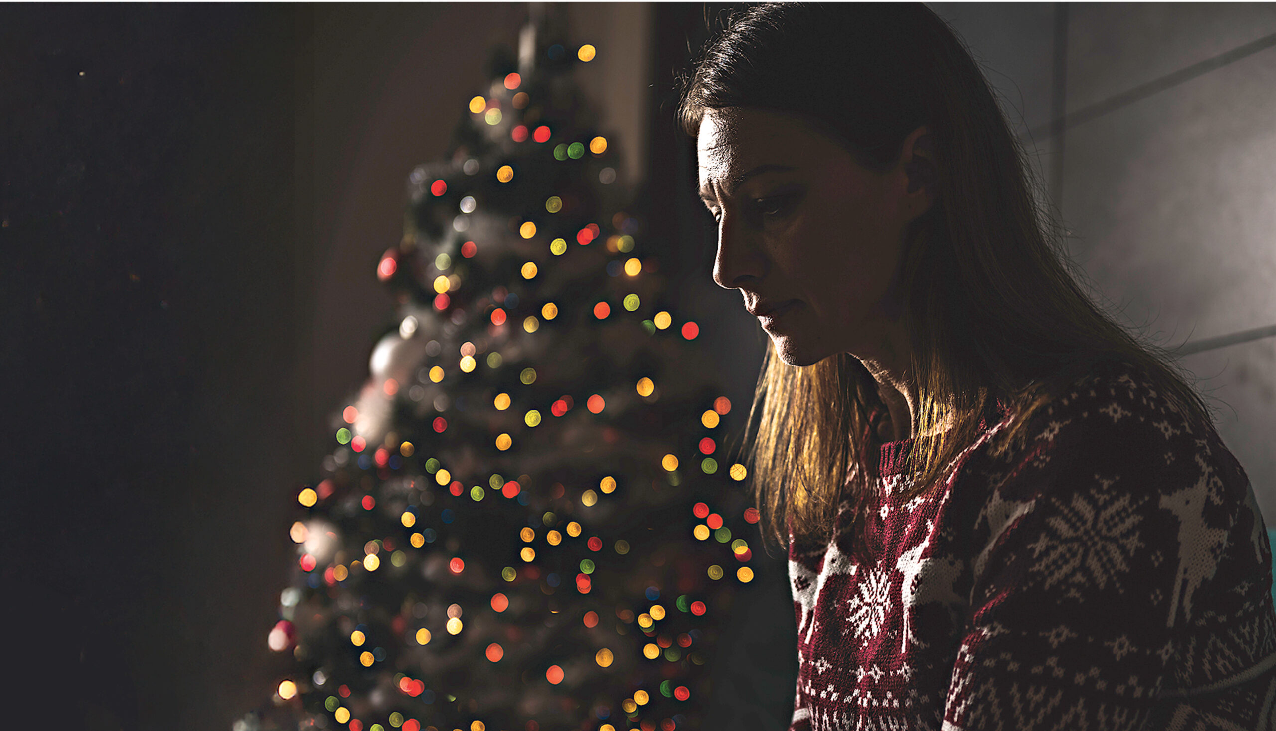 Lonely women sitting at home during christmas
