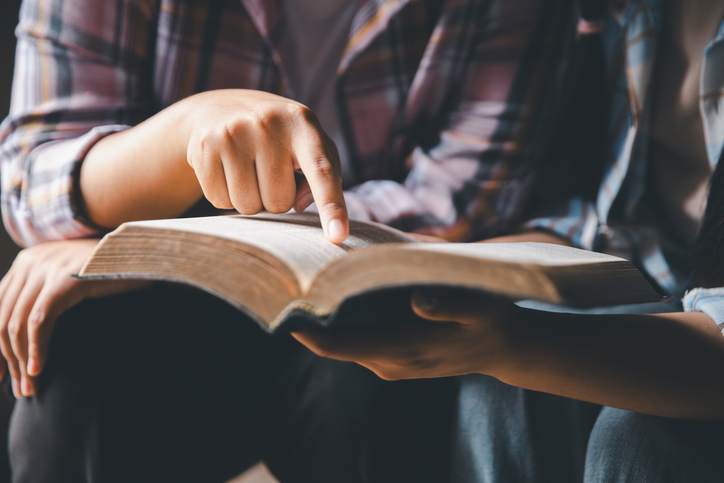 Close up group christians hands pray to God with spiritual faith on holy bible in catholic church. religion worship prayer ask god bless grace jesus believe. Christianity religion prayer holy worship