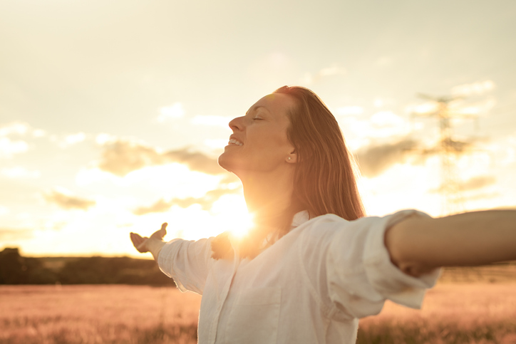 Woman feeling happy and free in a beautiful nature surroundings.