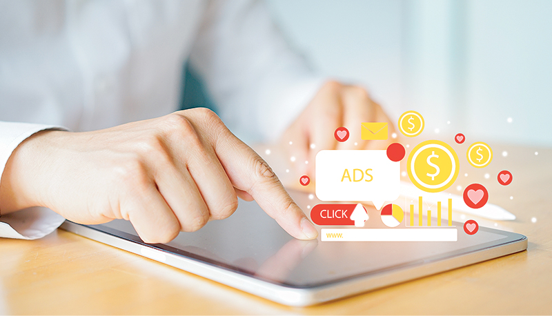 close up businessman hand touch screen on digital tablet to use marketing tool to announce promotion and special offer and checking traffic research of pay per click program on web page for online business and lifestyle concept