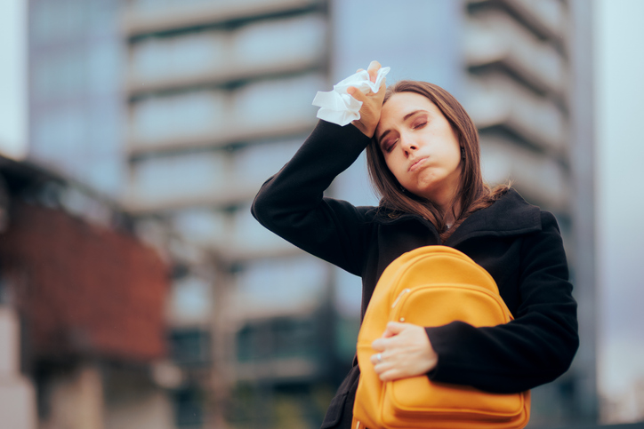 Woman Sweating Holding a Paper Tissue During Winter Season