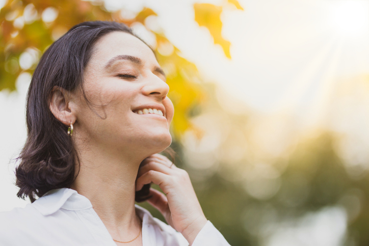 Smiling woman with sunset in the background