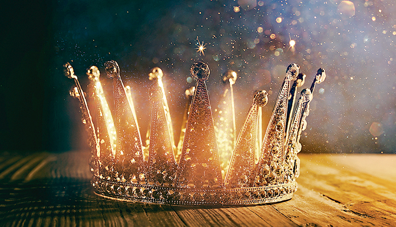 low key image of beautiful queen/king crown over wooden table. vintage filtered. fantasy medieval period