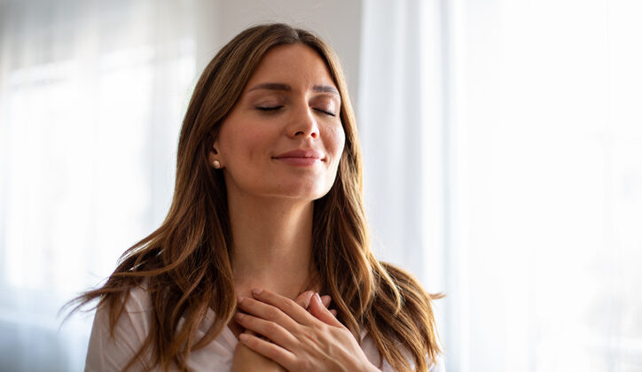 Serene woman practicing mindfulness with gratitude and deep breathing