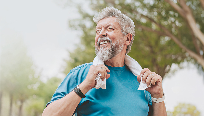 Portrait of a senior man exercising with a towel around his neck