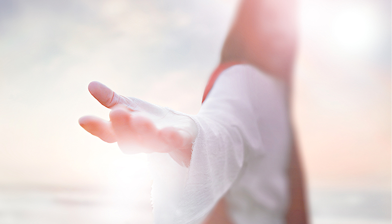 The resurrected Jesus Christ reaching out with open arms