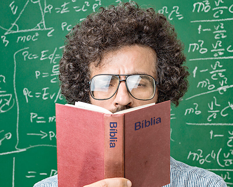 Portrait Of Mature Adult Scientist Reading Holy Bible