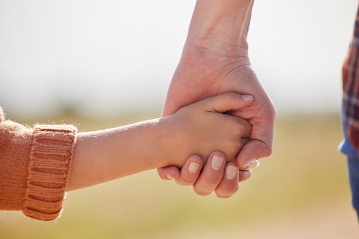 Cropped shot of a little girl holding her mother’s hand