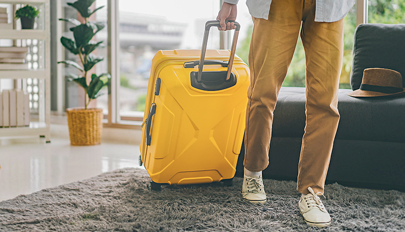 Single traveller tourism man walking carry a luggage begin a journey travel from home or hotel