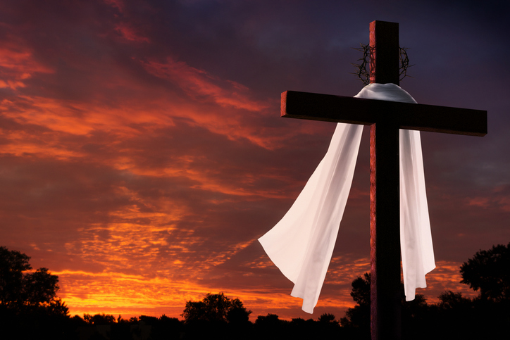 Dramatic Lighting on Christian Easter Morning Cross At Sunrise