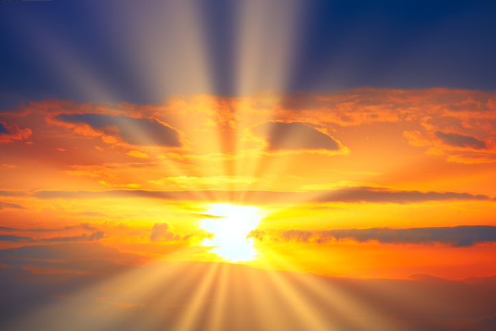 Spectacular orange sky with sun rays in the evening